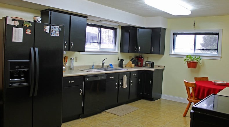 The eat-in kitchen offers an abundance of wood cabinetry as well as a large dining area.