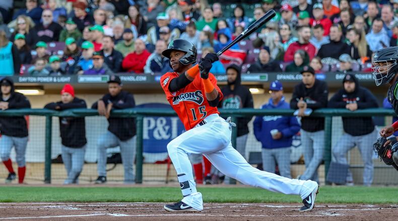 Dayton Dragons center fielder Mariel Bautista tries to elude a tag from Great Lakes Loons first baseman Dillon Paulson after getting caught in a rundown during the first inning of their game on Friday night at Fifth Third Field. The Dragons lost 7-5. CONTRIBUTED PHOTO BY MICHAEL COOPER