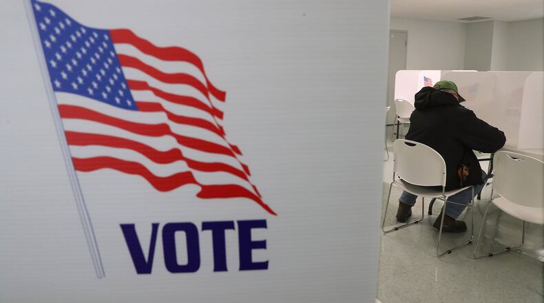 A man casts his vote at the Mad River Township election poll in the Knob Prairie United Church of Christ Tuesday. BILL LACKEY/STAFF