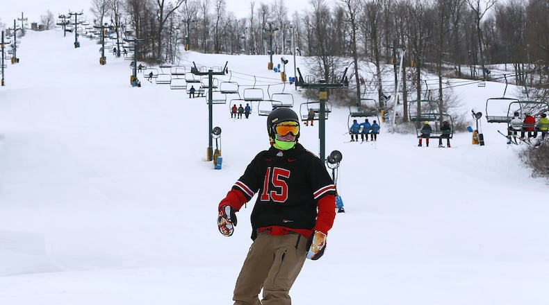 A snowboarder swishes down the slopes at Mad River Mountain earlier this month after it opened for season. The 14th annual Louie Vito Rail Jam for Charity will be held at Mad River on Saturday. Bill Lackey/Staff