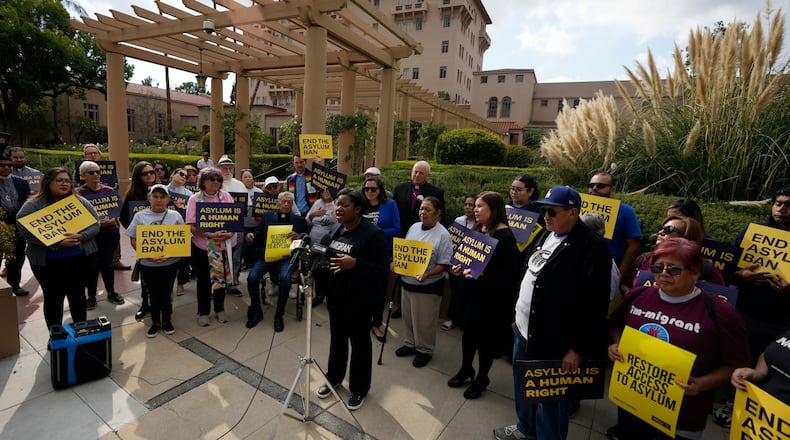 Guerline Jozef, Executive Director of the Haitian Bridge Alliance, speaks in front of demonstrators outside of the Richard H. Chambers U.S. Court of Appeals ahead of an asylum hearing, Tuesday, Nov. 7, 2023, in Pasadena, Calif. (AP Photo/Marcio Jose Sanchez)