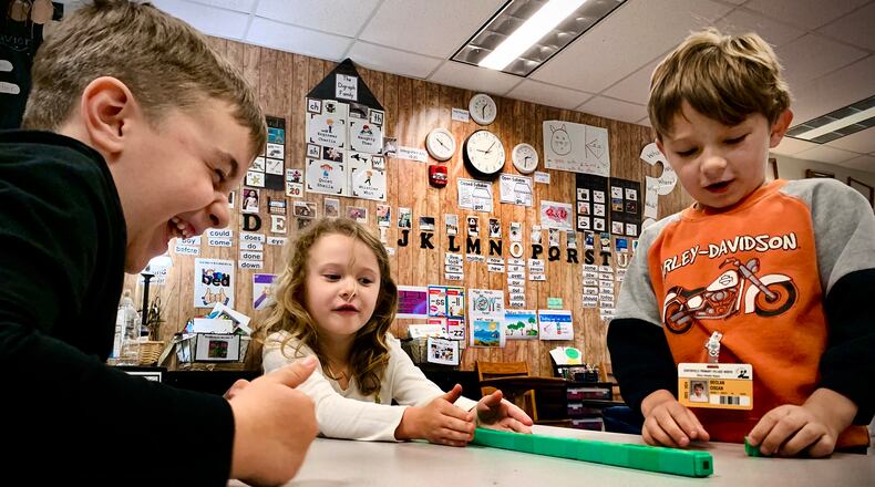 First-grade students (left to right) Parker Richey, Remi Kinney, and Declan Cogan work on counting skills in Sarah Jacobs' math class at Primary Village North school in Centerville in this 2024 photo. Centerville is nearly two years ahead in math scores using a new curriculum they rolled out two years ago. MARSHALL GORBY\STAFF