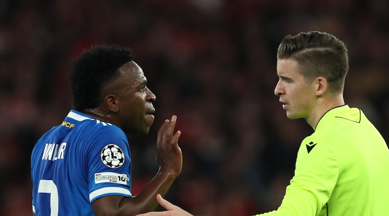 Real Madrid's Vinicius Junior argues with referee François Letexier after scoring the opening goal during a Champions League playoff soccer match between SL Benfica and Real Madrid in Lisbon, Portugal, Tuesday, Feb. 17, 2026. (AP Photo/Pedro Rocha)
