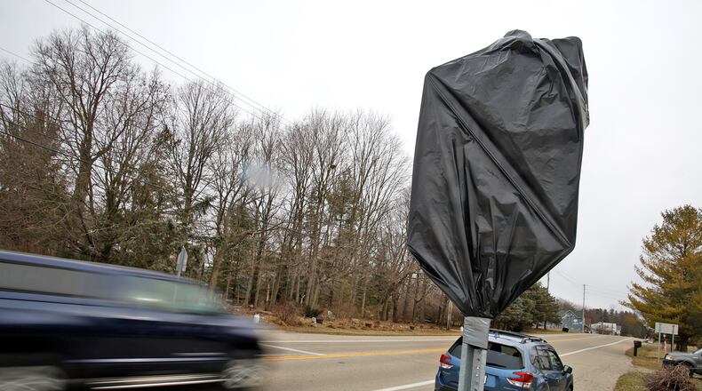 New U.S. 40 speed limit signs on the east end of Donnelsville are covered with plastic Friday, Feb. 16, 2024. The new signs will be uncovered soon and the speed limit lowered from 55 mph to 45 mph until drivers get to Enon Road. BILL LACKEY/STAFF