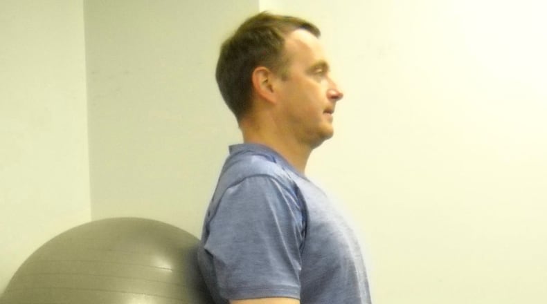 To complete a wall squat, the first step is to place a stability ball behind back. CONTRIBUTED