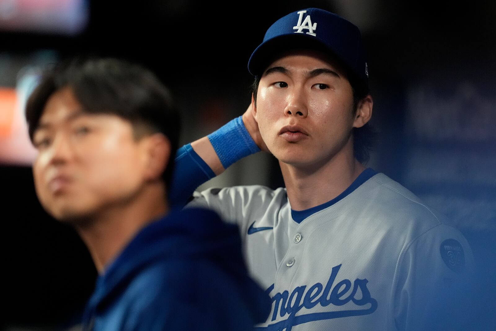 Los Angeles Dodgers' Hyeseong Kim stands in the dugout in the ninth inning of a baseball game against the Atlanta Braves, Sunday, May 4, 2025, in Atlanta. (AP Photo/Mike Stewart)