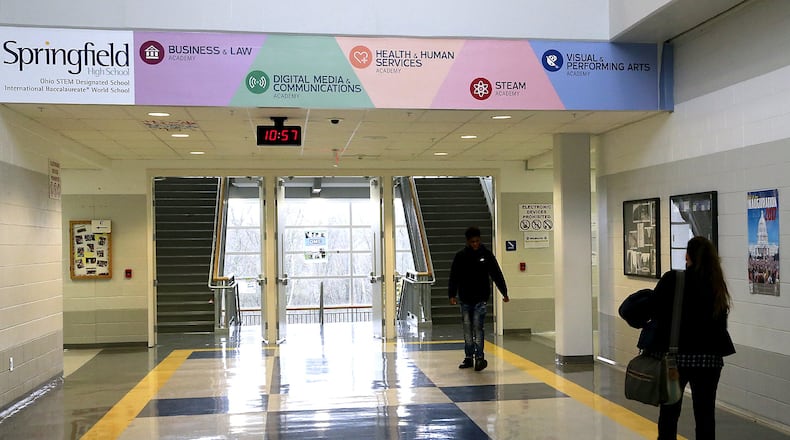 Students walk under a banner with the five academies at Springfield High School last month. Bill Lackey/Staff