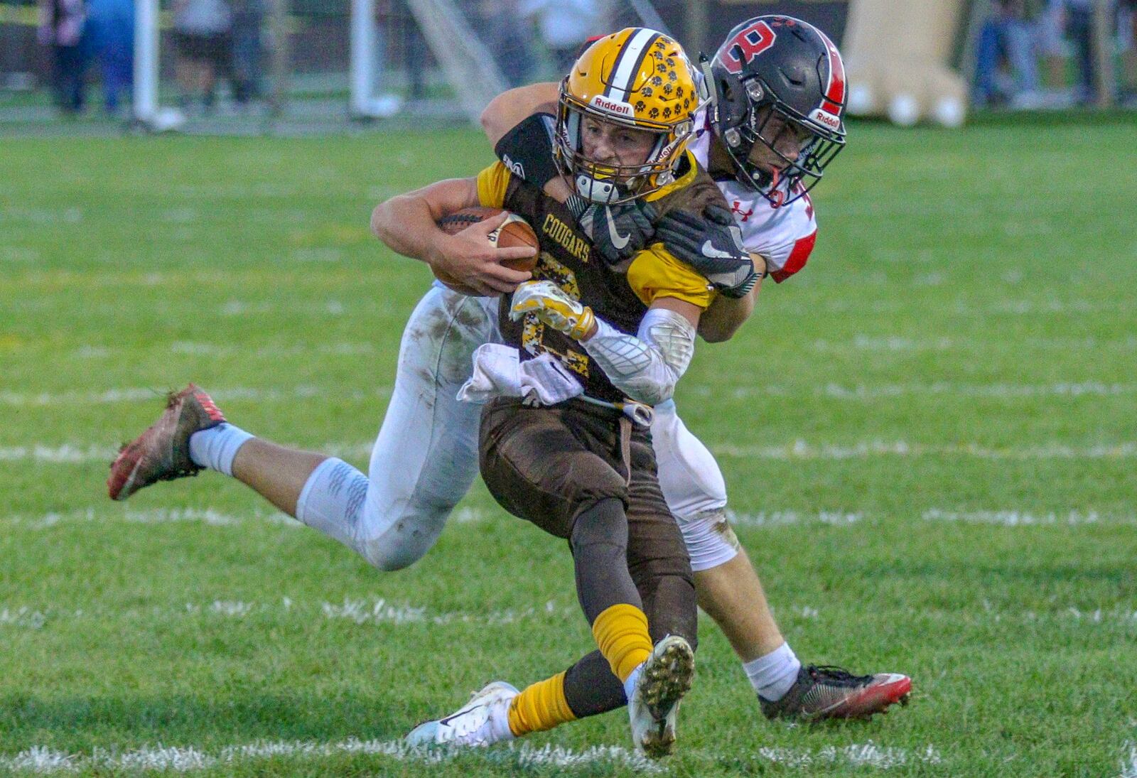 Kenton Ridge High School quarterback Dylan Lemen is tackled by Bellefontaine’s D.J. McDonald on Friday night at Richard L. Phillips Field in Springfield. The Chieftains won 34-7. Michael Cooper/CONTRIBUTED