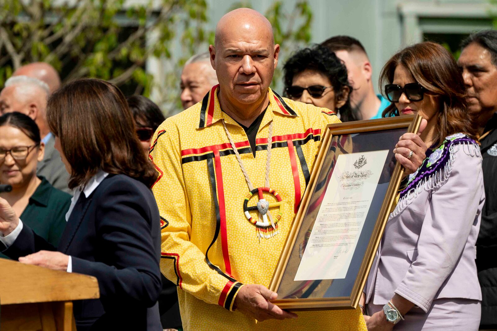 Seneca Nation president J. Conrad Seneca carries a proclamation of formal apology from New York Gov. Kathy Hochul on behalf of New York State for its role in operating the Thomas Indian School, Tuesday, May 20, 2025, outside the William Seneca Administration Building in Irving, N.Y. (Libby March/The Buffalo News via AP)