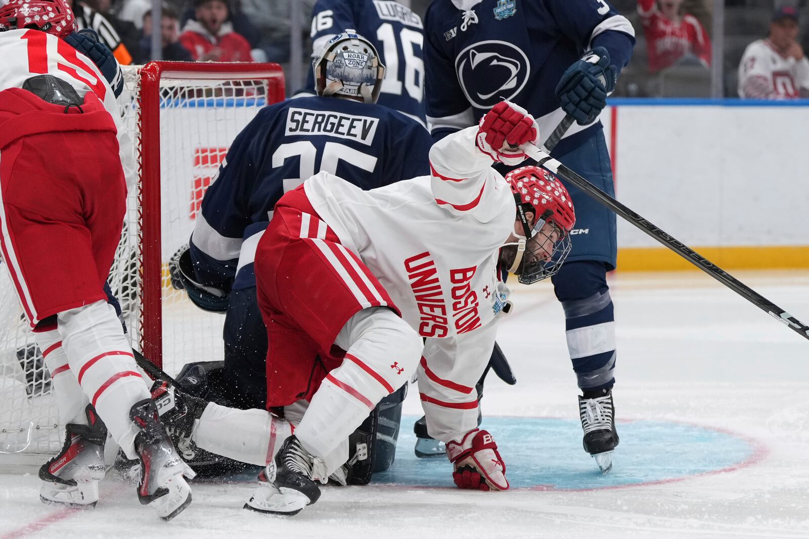 Boston University's Jack Hughes, right, celebrates after scoring past Penn State goaltender Arsenii Sergeev (35) during the second period in a semifinal game in the NCAA Frozen Four men's college hockey tournament, Thursday, April 10, 2025, in St. Louis (AP Photo/Jeff Roberson)