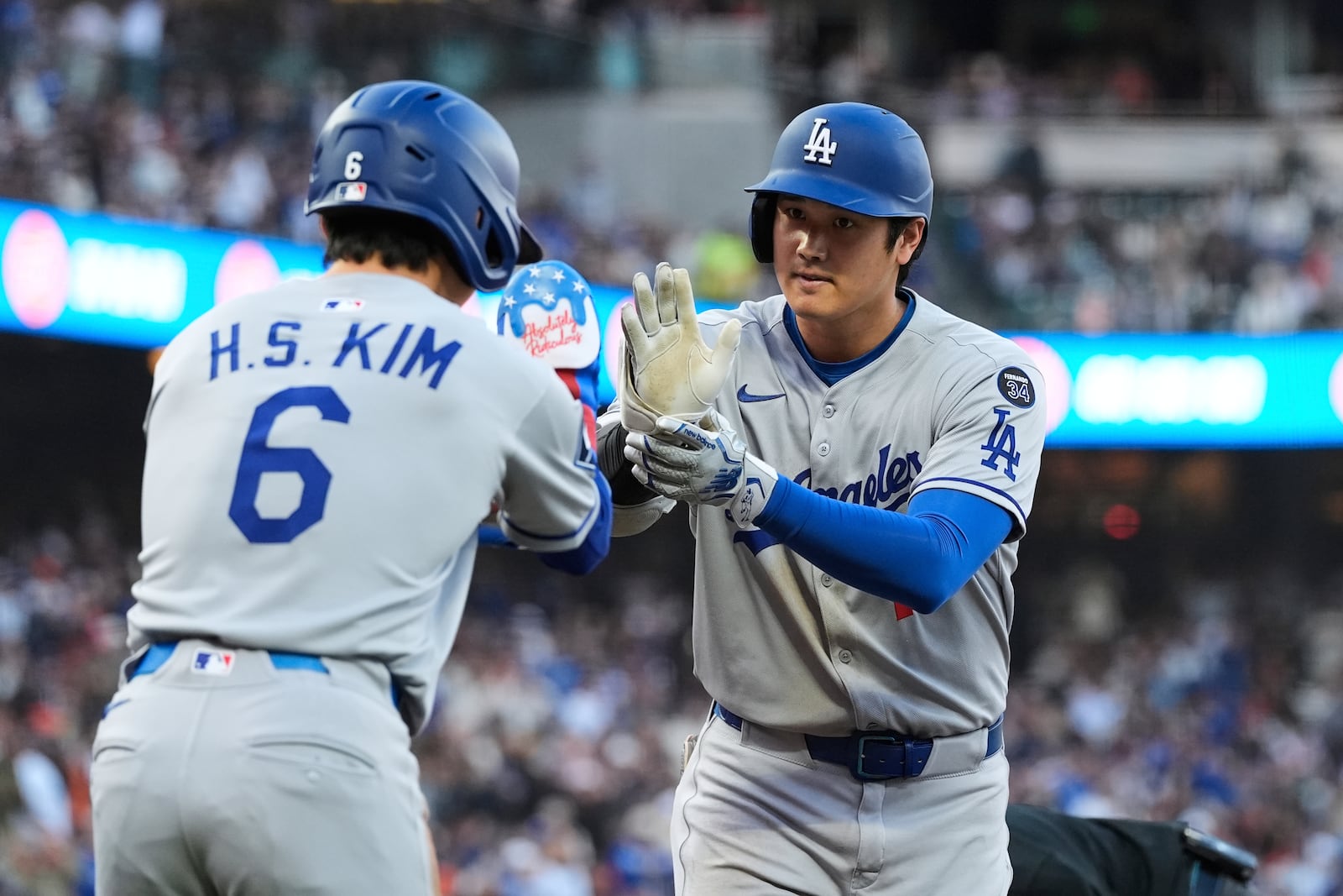 Los Angeles Dodgers' Shohei Ohtani, right, celebrates with Hyeseong Kim after hitting a two-run home run during the third inning of a baseball game against the San Francisco Giants, Friday, July 11, 2025, in San Francisco. (AP Photo/Godofredo A. Vásquez)
