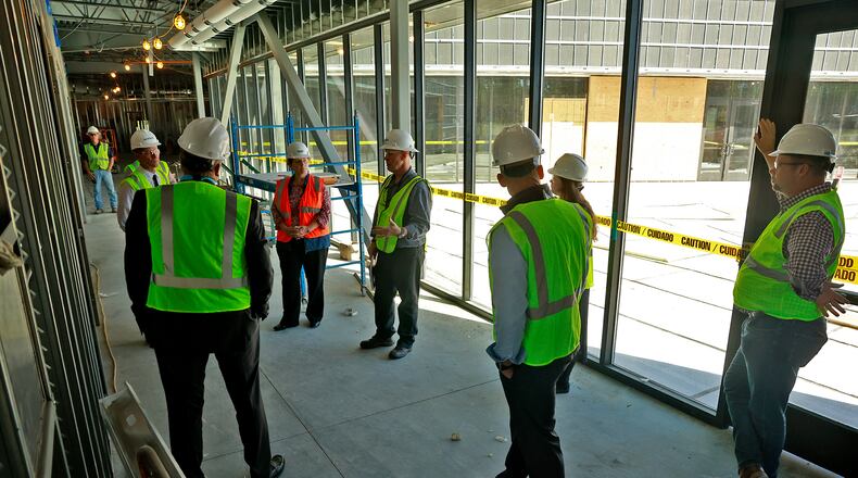 Members of the Global Impact STEM Academy Board of Directors took a tour of the school's new Upper Academy under construction on the Clark State College Leffel Lane campus last year. This new facility will help create more space to serve more students, which GISA Superintendent Josh Jennings said is part of what they're looking forward to in the future. BILL LACKEY/STAFF