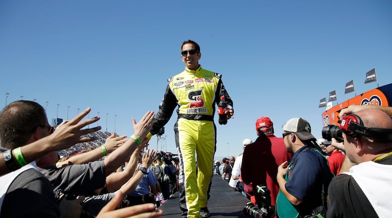 FILE - Greg Biffle greets fans during drivers introduction before the NASCAR Sprint Cup Series auto race at Chicagoland Speedway, Sept. 20, 2015, in Joliet, Ill. (AP Photo/Nam Y. Huh, File)