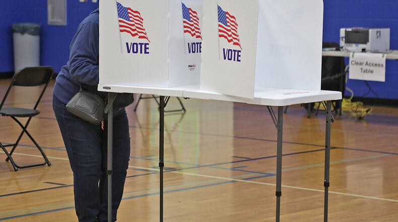 A voter fills out their ballots Tuesday at Roosevelt Middle School in the City of Springfield. BILL LACKEY/STAFF