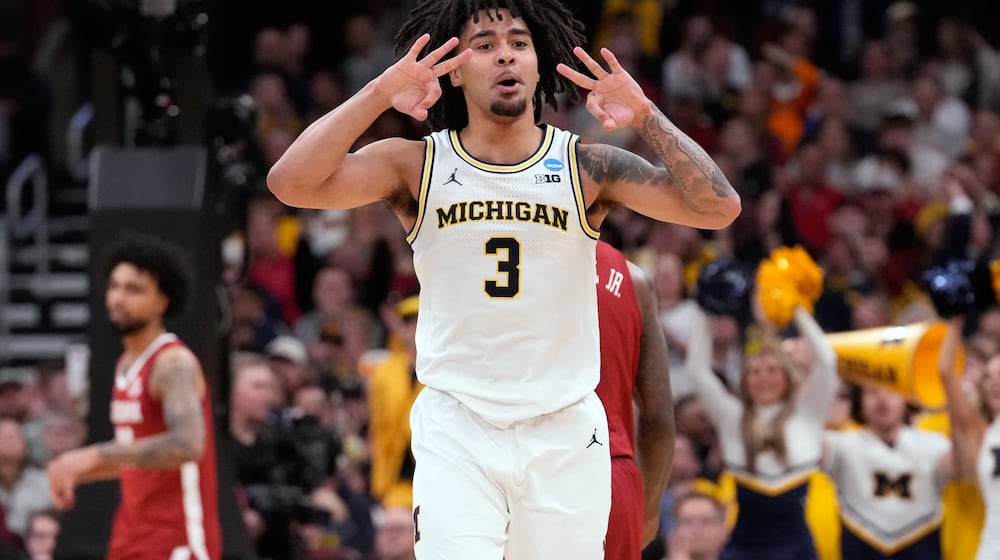 Michigan's Elliot Cadeau celebrates after making a 3-point basket during the second half in the Sweet 16 of the NCAA college basketball tournament against Alabama, Friday, March 27, 2026, in Chicago. (AP Photo/Nam Y. Huh)