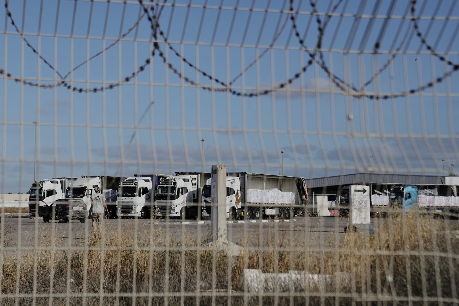 Trucks load with humanitarian aid for the Gaza Strip are seen at the Kerem Shalom Crossing in southern Israel, Tuesday May 20, 2025. (AP Photo/Maya Alleruzzo)