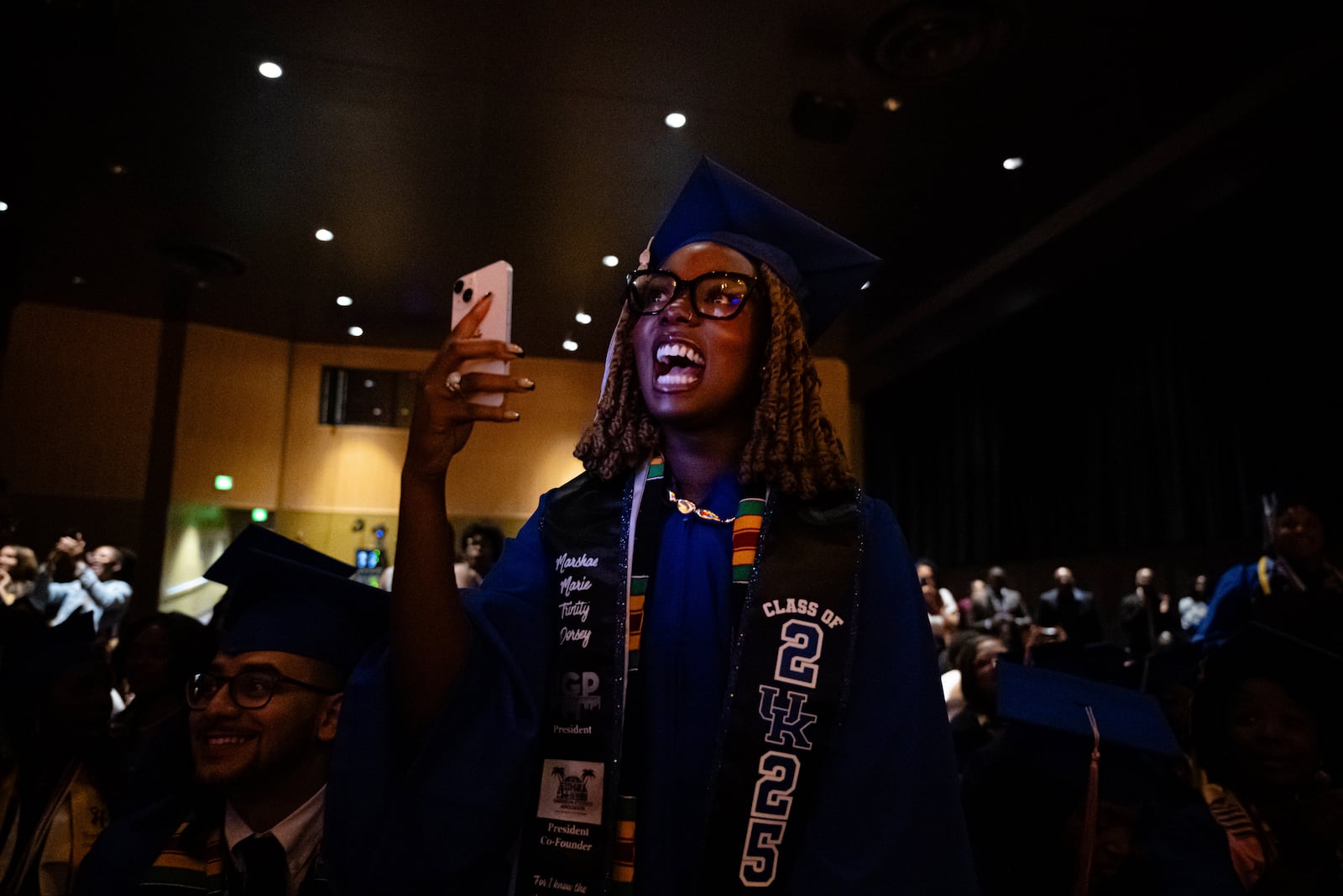 A graduate cheers on their fellows during the Senior Salute at Lyric Theatre in Lexington, Ky., Wednesday, May 7, 2025. (AP Photo/Jon Cherry)