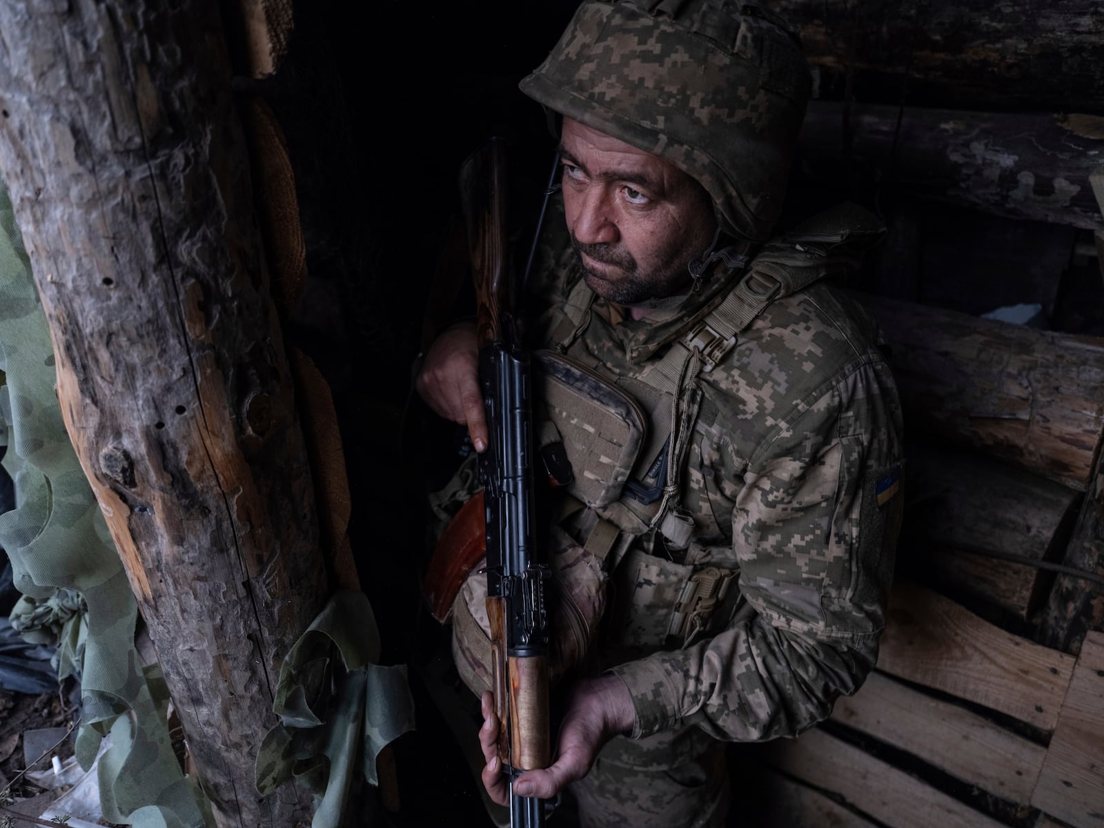 FILE - In this photo provided by Ukraine's 93rd Kholodnyi Yar Separate Mechanized Brigade press service, a soldier looks out of a shelter on the anti-drone firing position in Kostyantynivka, the site of the heavy battles with the Russian troops in the Donetsk region, Ukraine, April 24, 2025. (Iryna Rybakova/Ukraine's 93rd Mechanized Brigade via AP, File)