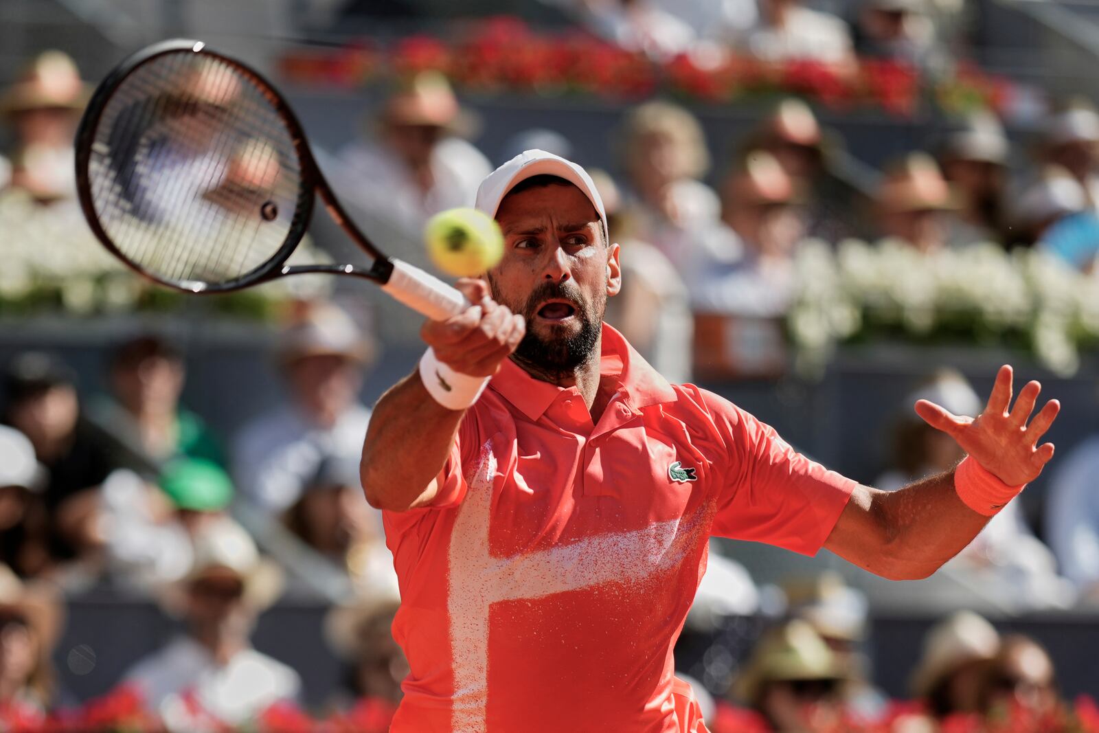 Novak Djokovic of Serbia returns the ball against Matteo Arnaldi of Italy during the Madrid Open tennis tournament in Madrid, Spain, Saturday, April 26, 2025. (AP Photo/Manu Fernandez)