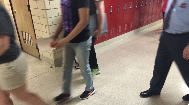 Urbana High School students and teachers are shown walking through the hallways.
