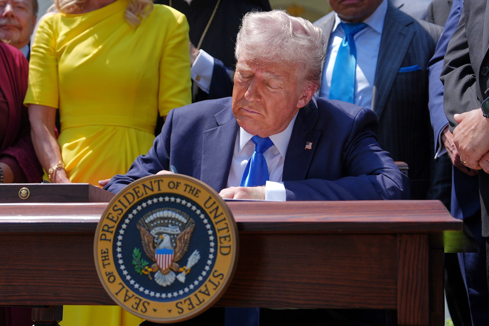President Donald Trump signs an executive order establishing the Religious Liberty Commission, during a National Day of Prayer event in the Rose Garden of the White House, Thursday, May 1, 2025, in Washington. (AP Photo/Evan Vucci)