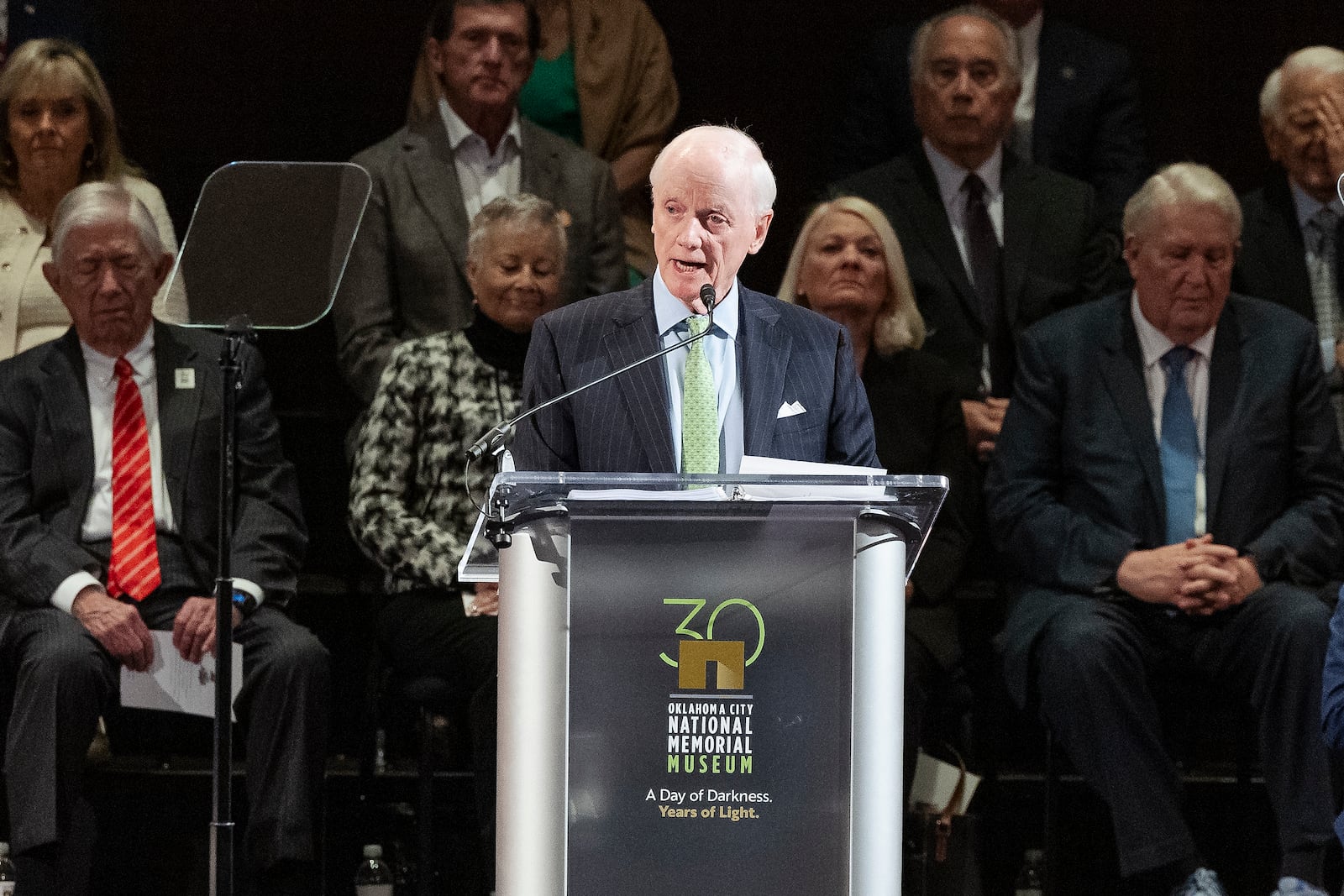 Former Oklahoma Governor Frank Keating speaks to guest during the 30th anniversary memorial service for the victims of the 1995 Oklahoma City bombing, in Oklahoma City, Saturday, April 19, 2025. (AP Photo/Alonzo Adams)