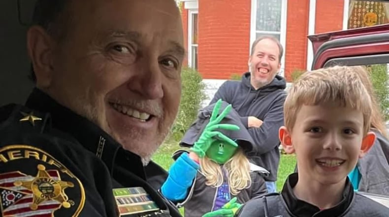 FILE PHOTO: Greene County Sheriff Gene Fischer met a young law enforcement officer out trick-or-treating on Halloween, Sunday, Oct. 31, 2021.