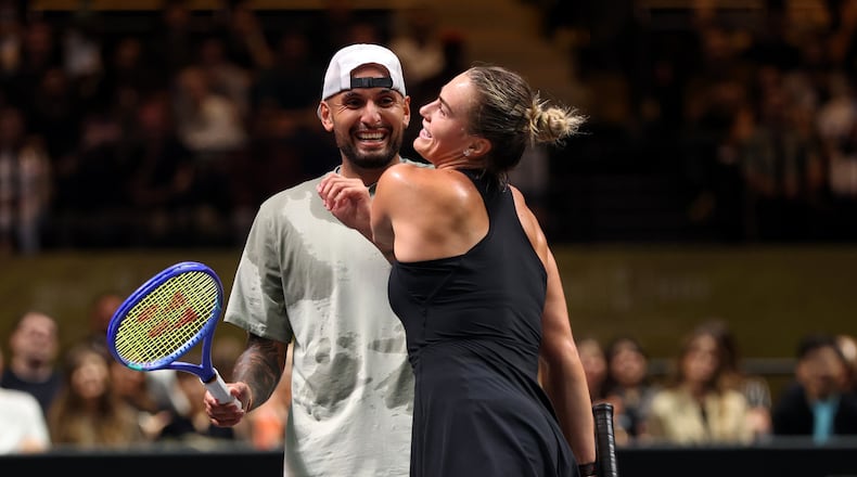 Nick Kyrgios, left, and Aryna Sabalenka interact at the net during their Battle of the Sexes match, in Dubai, United Arab Emirates, Sunday Dec. 28, 2025. (Christopher Pike/Pool Photo via AP)