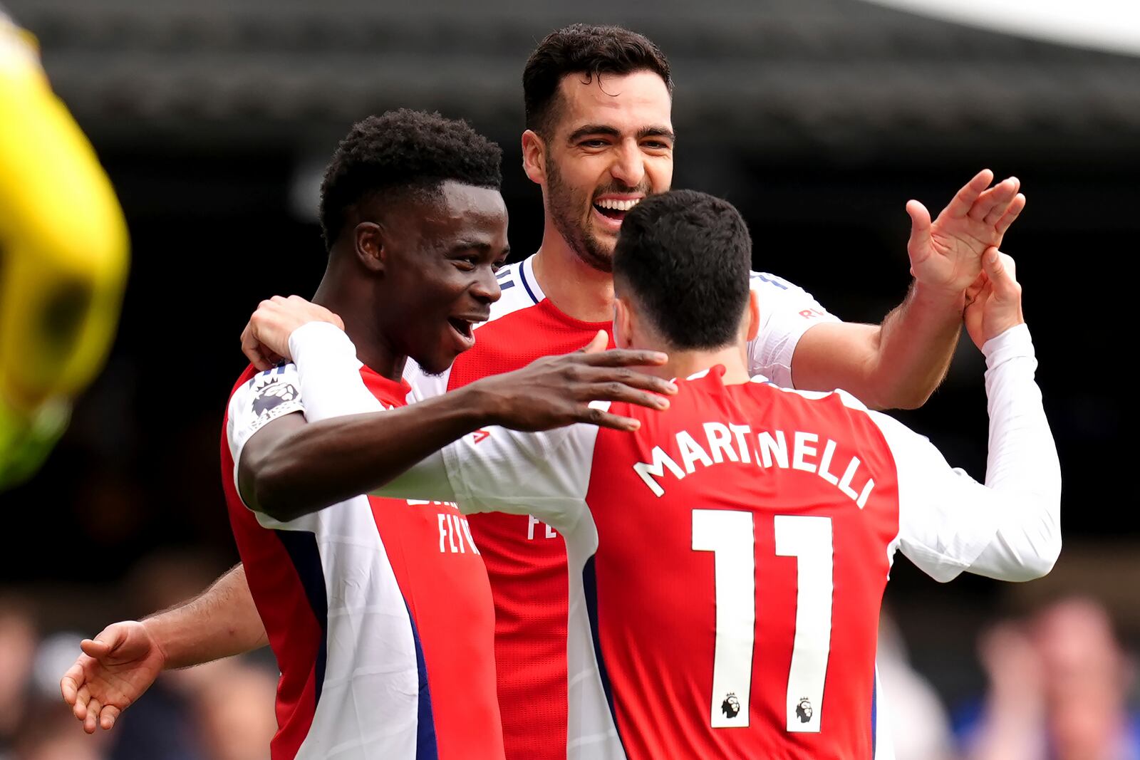 Arsenal's Gabriel Martinelli, right, celebrates scoring their side's second goal of the game during the English Premier League soccer match between Ipswich Town and Arsenal at Portman Road, Ipswich, England, Sunday, April 20, 2025. (John Walton/PA via AP)