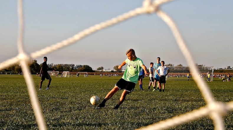 Xane Grigsby kicks a goal during soccer practice Tuesday evening at the Eagle City Soccer Complex. Bill Lackey/Staff