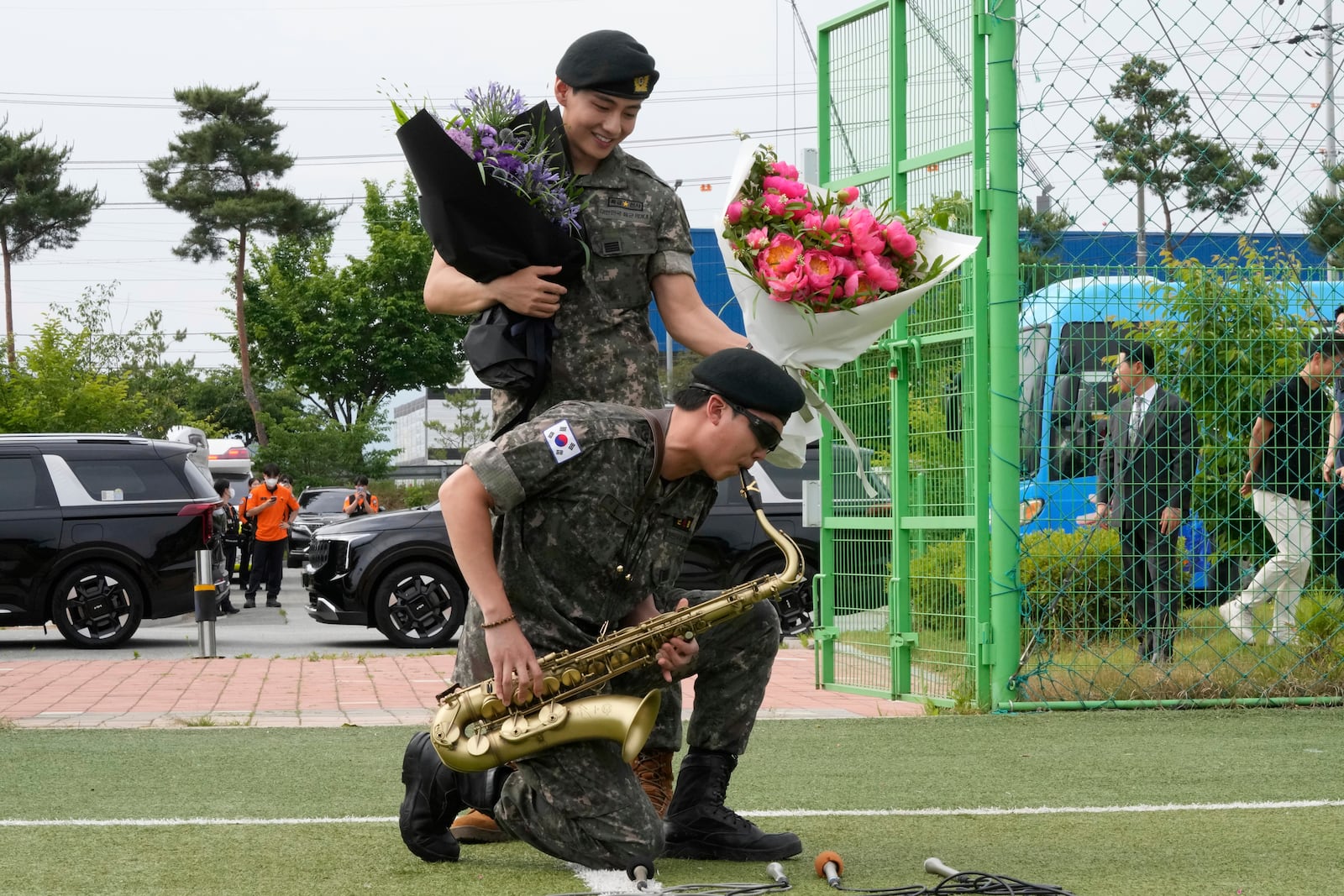 K-pop band BTS members RM, bottom, and V react after being discharged from a mandatory military service in Chuncheon, South Korea, Tuesday, June 10, 2025. (AP Photo/Ahn Young-joon)