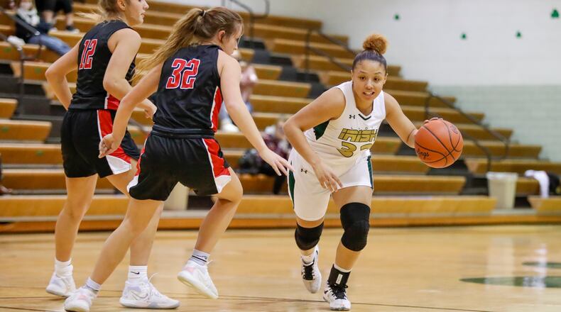 Catholic Central High School senior Abbigail Peterson drives past Cedarville senior Elly Coe during their game on Jan. 27 at Jason Collier Gymnasium in Springfield. Michael Cooper/CONTRIBUTED