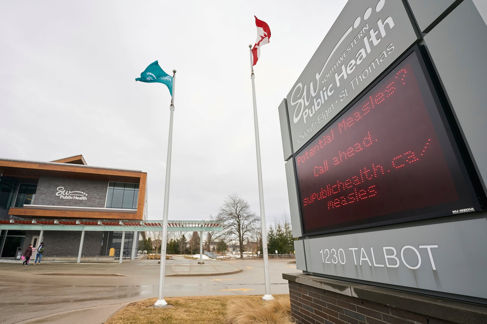 A sign outside Southwestern Public Health in St. Thomas, Ontario, Canada, on Tuesday, March 4, 2025, warns residents to call ahead before visiting a doctor or hospital if they think they have the measles. (Geoff Robins/The Canadian Press via AP)