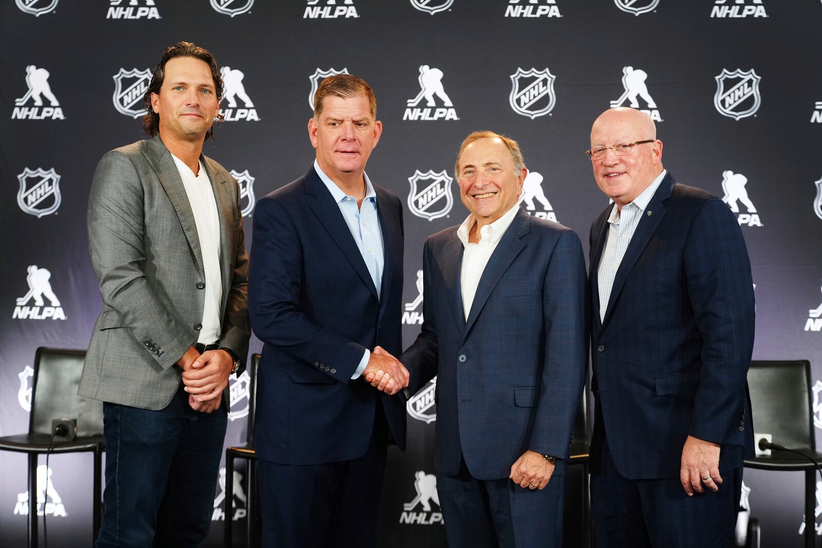 From left to right, Ron Hainsey, NHLPA Assistant Executive Director, Marty Walsh, NHLPA Executive Director, Gary Bettman, NHL Commissioner, and Bill Daly, NHL Deputy Commissioner, pose for photos after a joint press conference before the NHL hockey draft Friday, June 27, 2025, in Los Angeles. (AP Photo/Damian Dovarganes)
