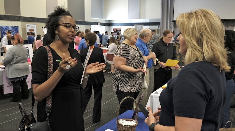 This file photo shows an exchange at a job fair held in Clark County in 2017. A virtual career fair will be held next week targeting Clark and Champaign counties with the goal of connecting over 35 companies with jobseekers amid the coronavirus pandemic. Bill Lackey/Staff