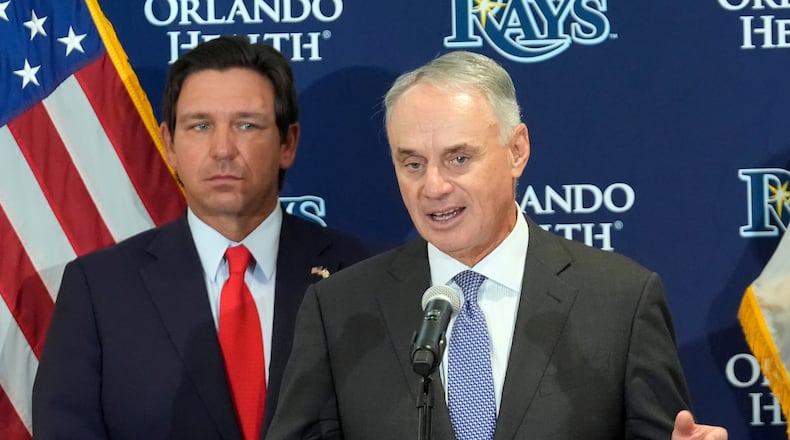 Major League Baseball commissioner Rob Manfred, right, speaks during a new baseball stadium news conference as Florida Gov. Ron DeSantis looks, Tuesday, Feb. 3, 2026, at Hillsborough College in Tampa, Fla. (AP Photo/Chris O'Meara)