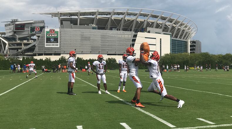 Cincinnati Bengals wide receiver and Lakota West graduate Kayaune Ross (right) goes through a blocking drill with Josh Malone during Monday’s practice at Paul Brown Stadium. JAY MORRISON/STAFF