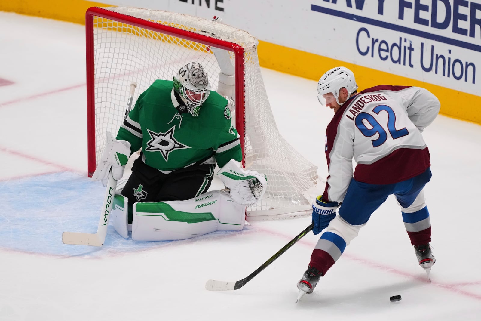 Colorado Avalanche's Gabriel Landeskog (92) loses control of the puck as he pressures Dallas Stars goaltender Jake Oettinger, left, in the third period in Game 7 of a first-round NHL hockey playoff series Saturday, May 3, 2025, in Dallas. (AP Photo/Julio Cortez)