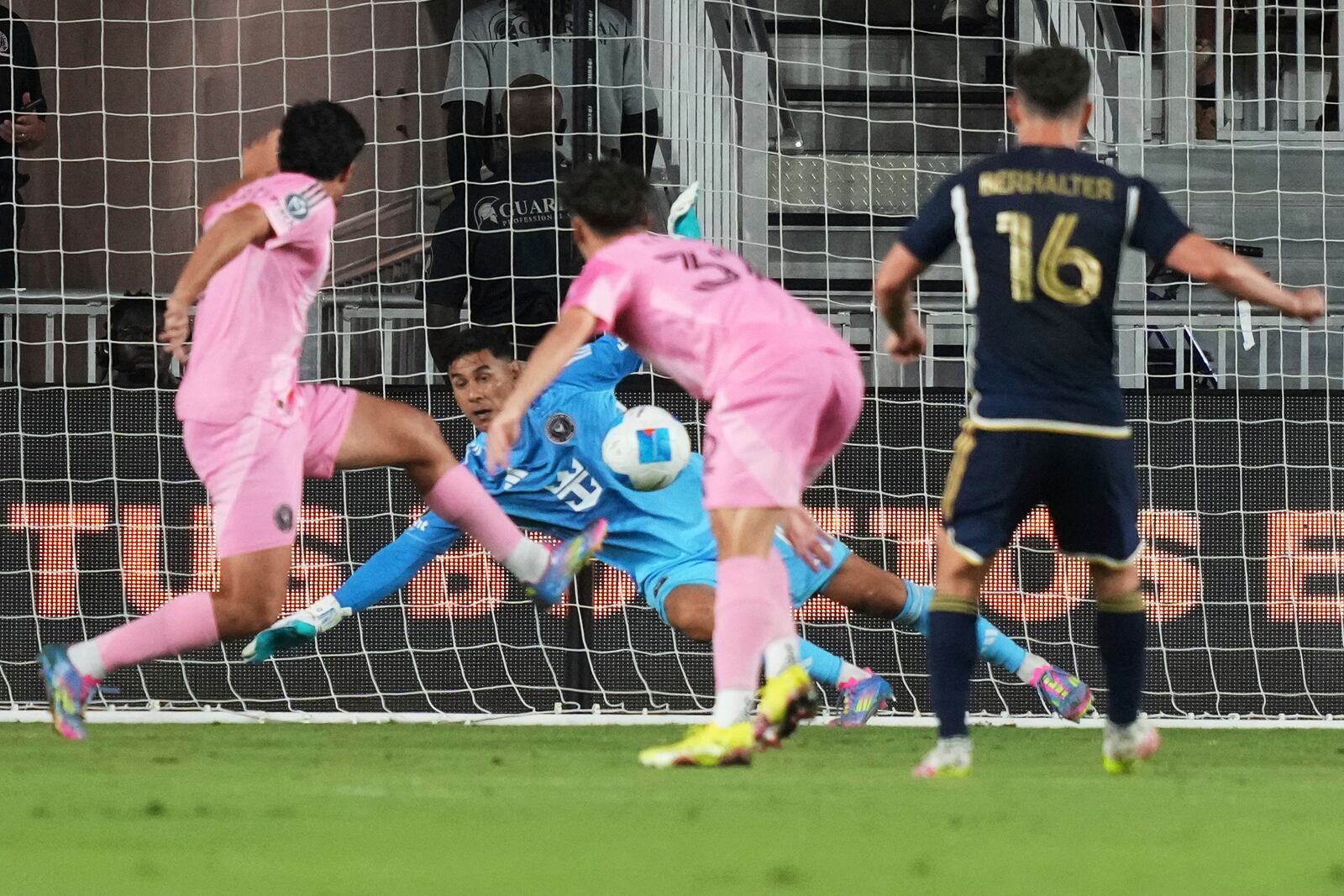 Inter Miami goalkeeper Óscar Ustari, center, can't stop a ball kicked by Vancouver Whitecaps midfielder Sebastian Berhalter (16) for a goal during the second half of a CONCACAF Champions Cup second-leg semifinal soccer match, Wednesday, April 30, 2025, in Fort Lauderdale, Fla. (AP Photo/Lynne Sladky)
