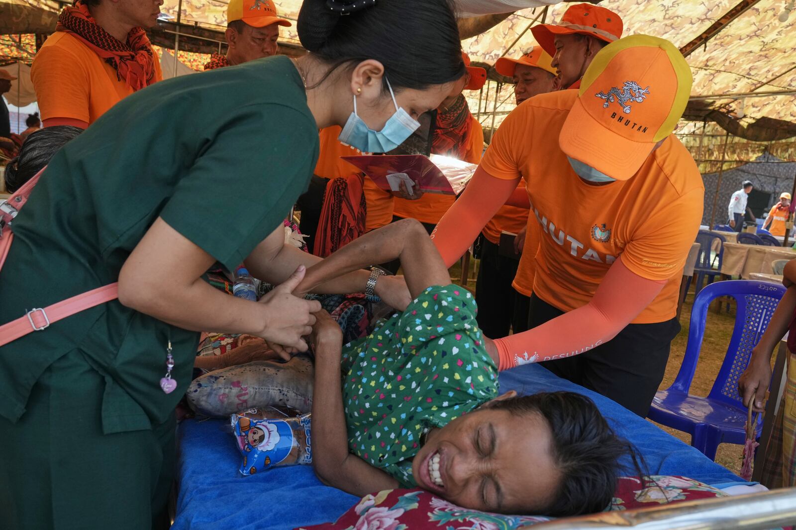 A Bhutan medical volunteer attends to a patient at their make-shift tent after last week's earthquake in Naypyitaw, Myanmar, Friday, April 4, 2025. (AP Photo)