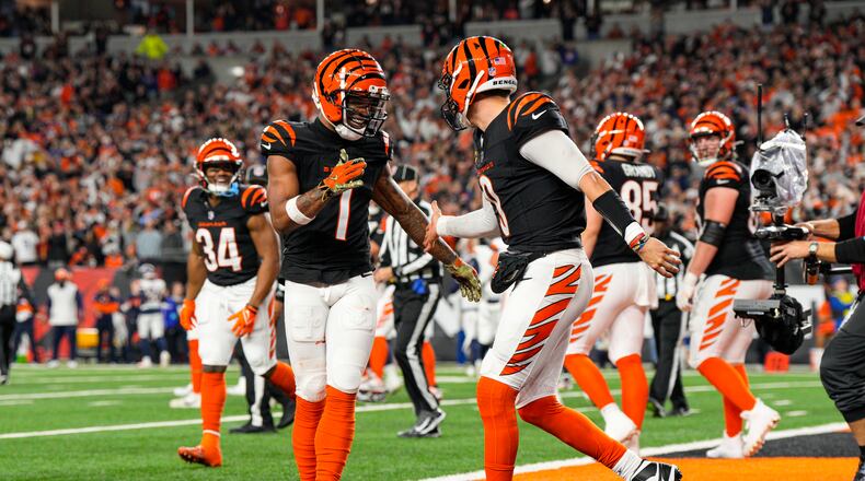 Cincinnati Bengals quarterback Joe Burrow (9) celebrates with wide receiver Ja'Marr Chase (1) after a touchdown against the Denver Broncos during the second half of an NFL football game in Cincinnati, Saturday, Dec. 28, 2024. (AP Photo/Jeff Dean)