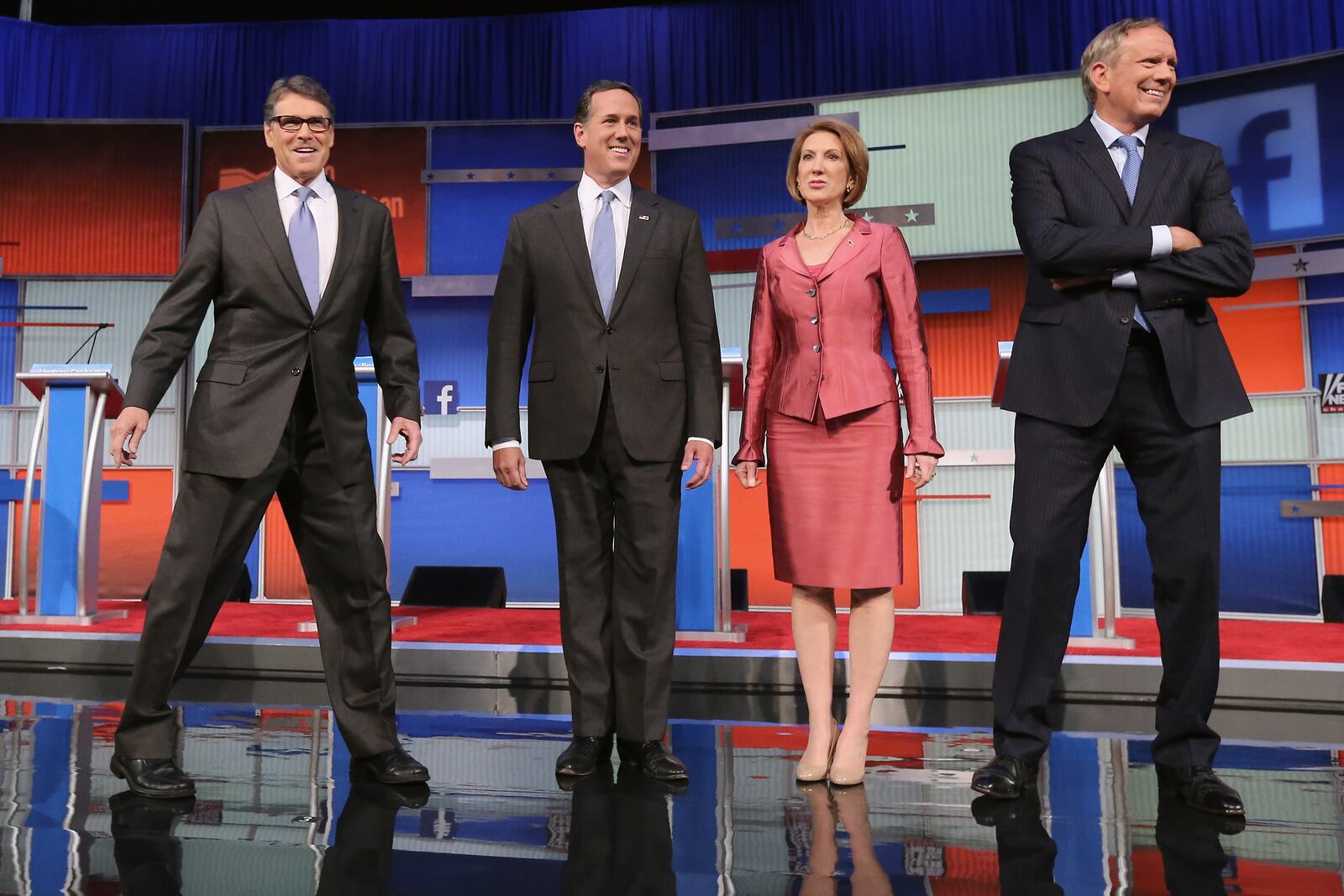 CLEVELAND, OH - AUGUST 06: Republican presidential candidates (L-R) Rick Perry, Rick Santorum, Carly Fiorina and George Pataki take the stage for a presidential pre-debate forum hosted by FOX News and Facebook at the Quicken Loans Arena August 6, 2015 in Cleveland, Ohio. Seven GOP candidates were selected to participate in the forum based on their rank in an average of the five most recent national political polls. (Photo by Chip Somodevilla/Getty Images)