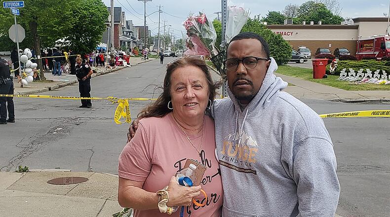 Dion Green, who lost his father in the Oregon District shooting, stands Wednesday with a woman he met outside Tops Supermarket, the scene of a recent mass shooting. Green said the woman was in need of support, so he hugged her and talked to her after he drove to Buffalo to help people impacted by the shooting. Contributed Photo