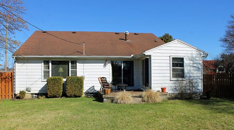 The backyard is surrounded by a tall privacy fence.