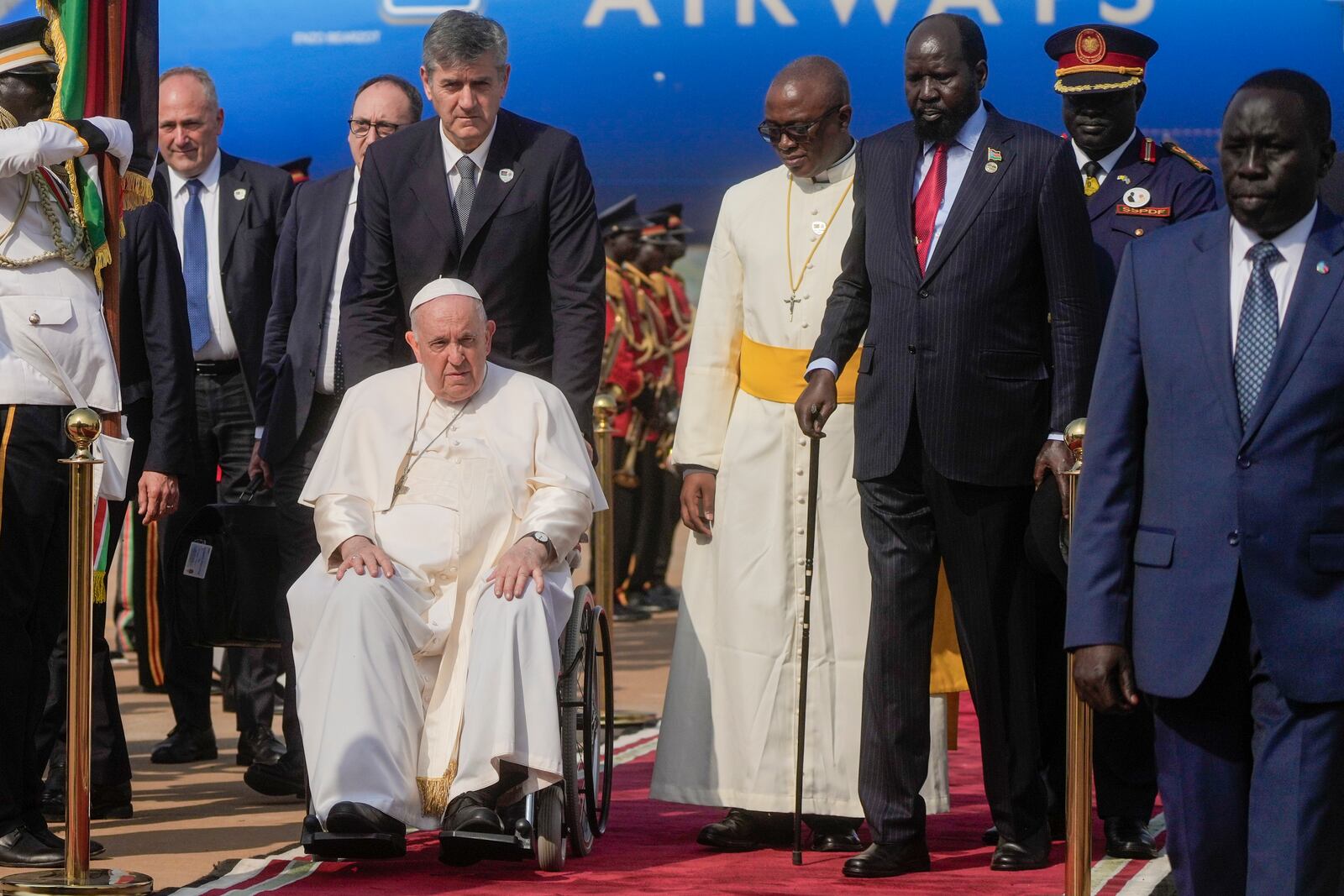 Pope Francis is welcomed by South Sudan's President Salva Kiir, second from right, upon his arrival at Juba's airport, South Sudan, Friday, Feb. 3, 2023. Francis is in South Sudan on the second leg of a six-day trip that started in Congo, hoping to bring comfort and encouragement to two countries that have been riven by poverty, conflicts and what he calls a "colonialist mentality" that has exploited Africa for centuries. (AP Photo/Gregorio Borgia)