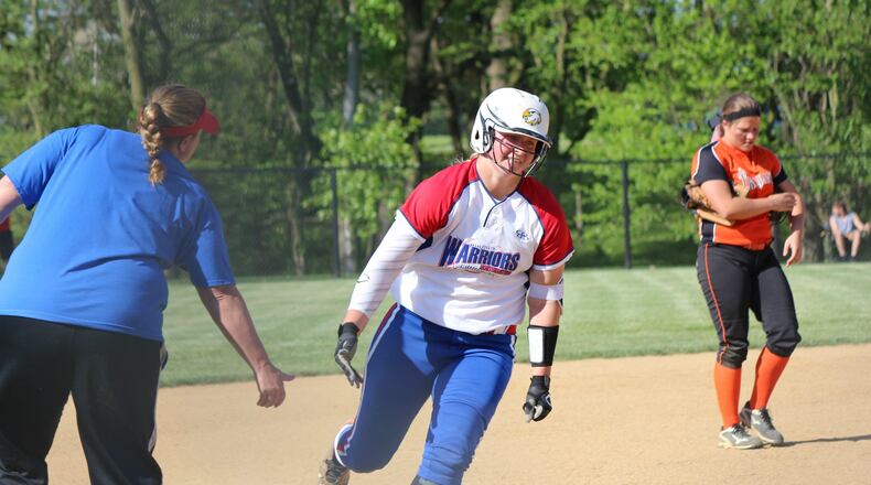 Northwestern coach Missy Johnson congratulates junior Jenna Robbins after Robbins hit a three-run homer Monday against Arcanum. Greg Billing/Contributed photo