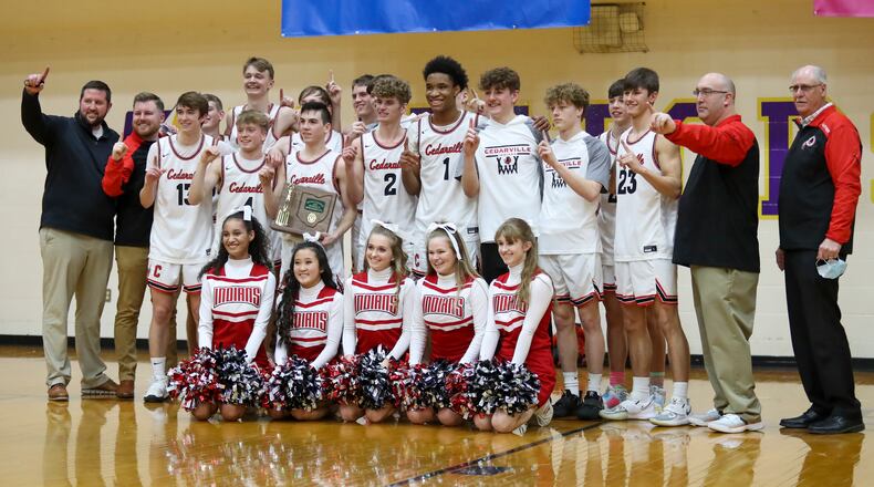 The Cedarville High School boys basketball team poses with the trophy after beating Jackson Center 50-48 on Saturday afternoon at the Vandalia Butler Student Activity Center to win its first district championship since 2005. Michael Cooper/CONTRIBUTED