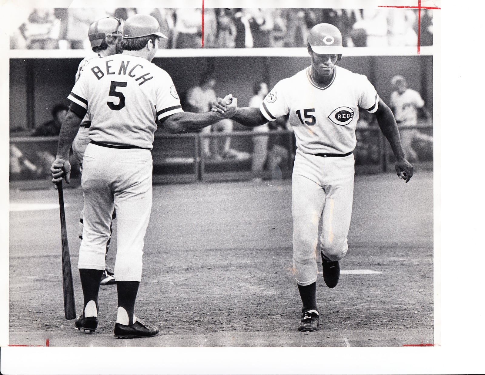 Johnny Bench greets George Foster at home plate.