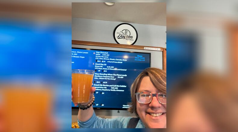 Alexis Larsen holds a pint of Tangerine New England IPA from New Ales Brewing that was named after her. FILE