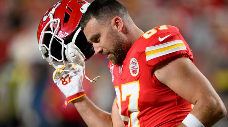 FILE - Kansas City Chiefs tight end Travis Kelce takes off his helmet during warmups before an NFL football game against the Denver Broncos, Dec. 25, 2025, in Kansas City, Mo. (AP Photo/Reed Hoffmann, File)